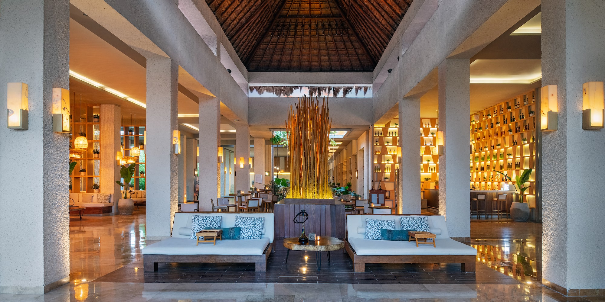 a large room with a large fountain and couches