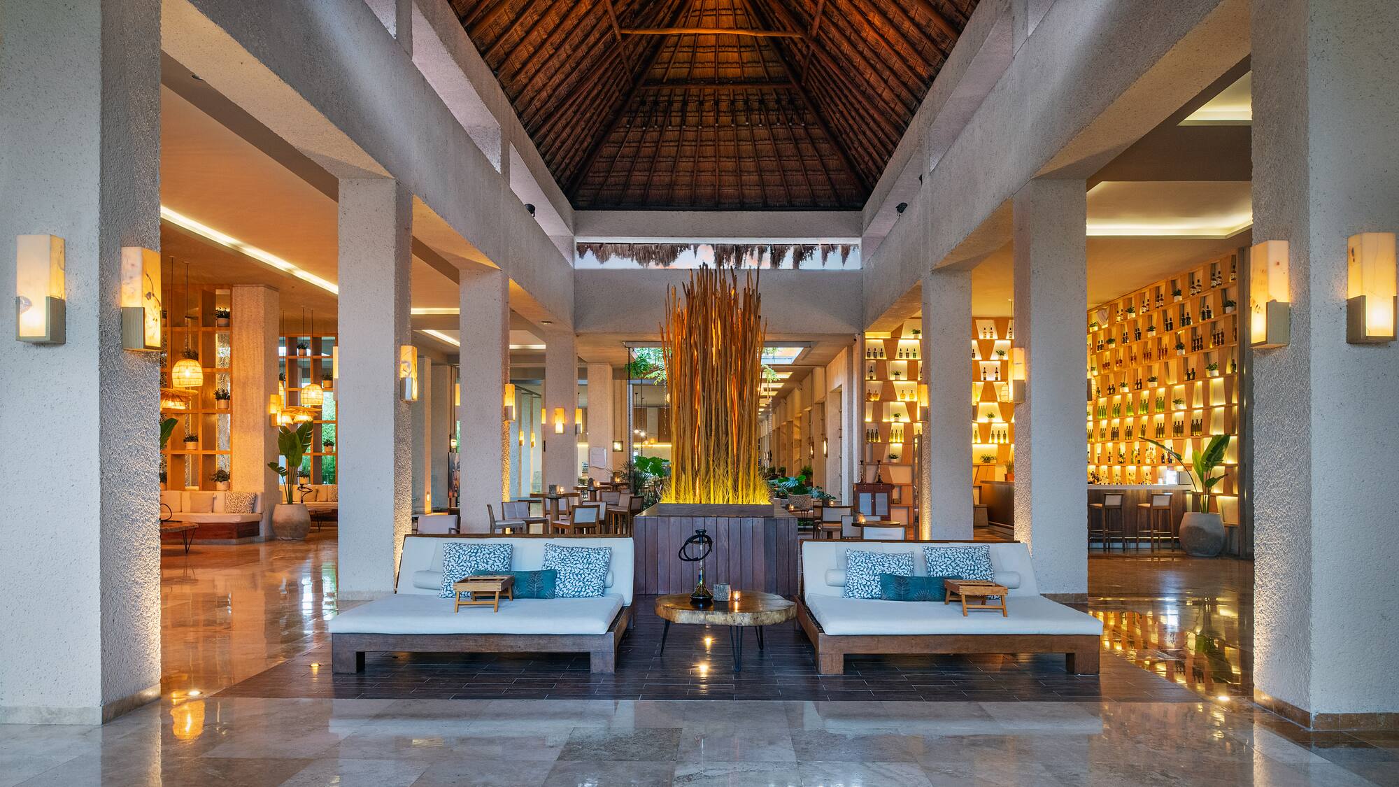 a large room with a large fountain and couches