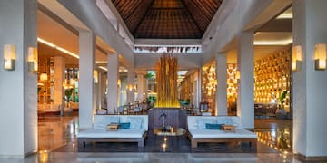 a large room with a large fountain and couches