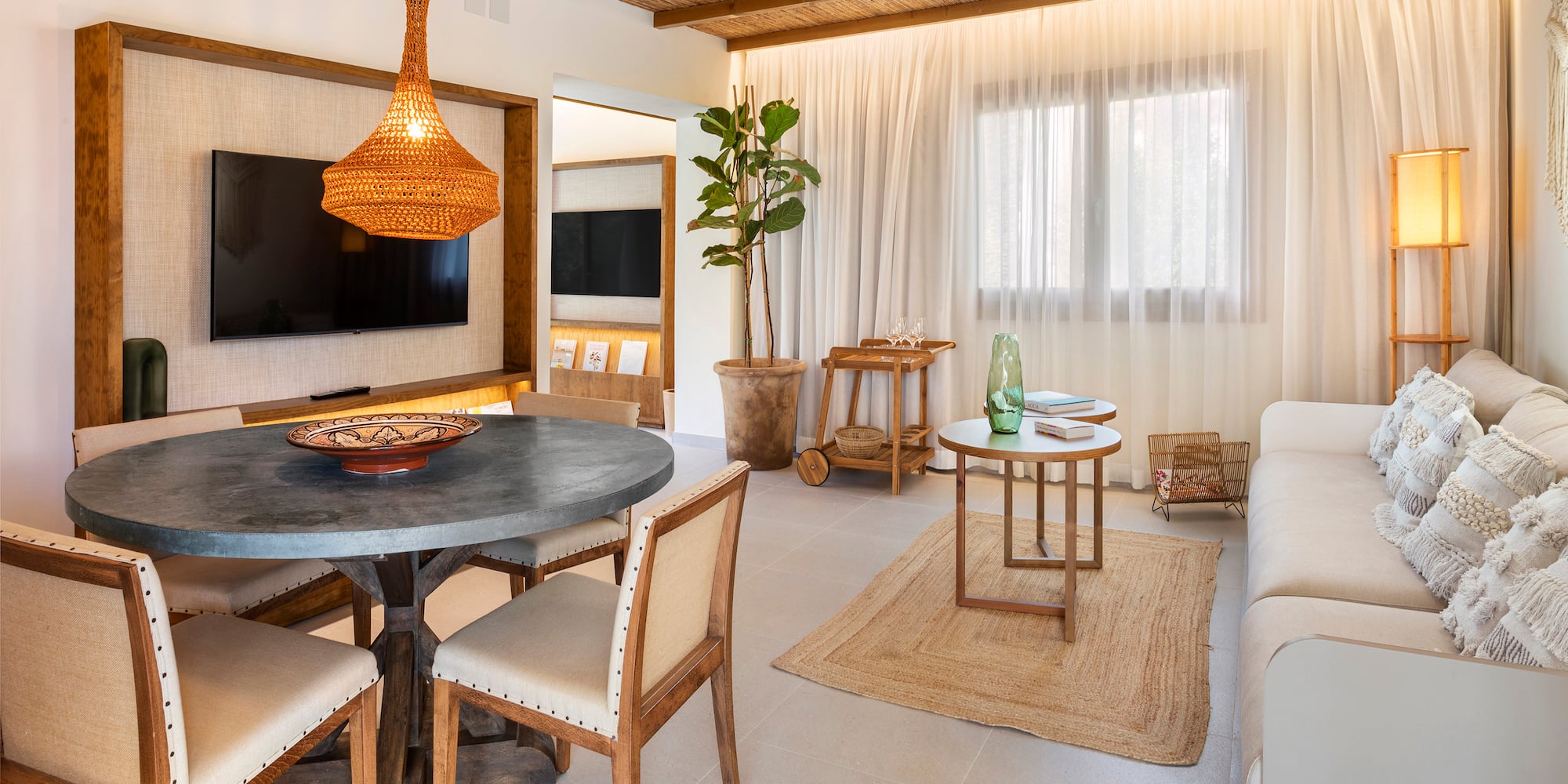 a living room with a table and chairs