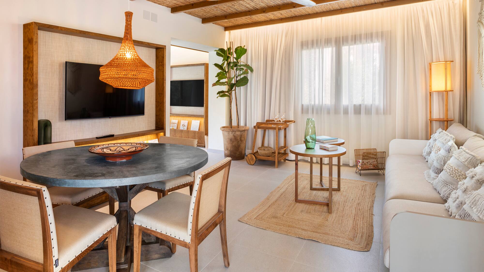 a living room with a table and chairs