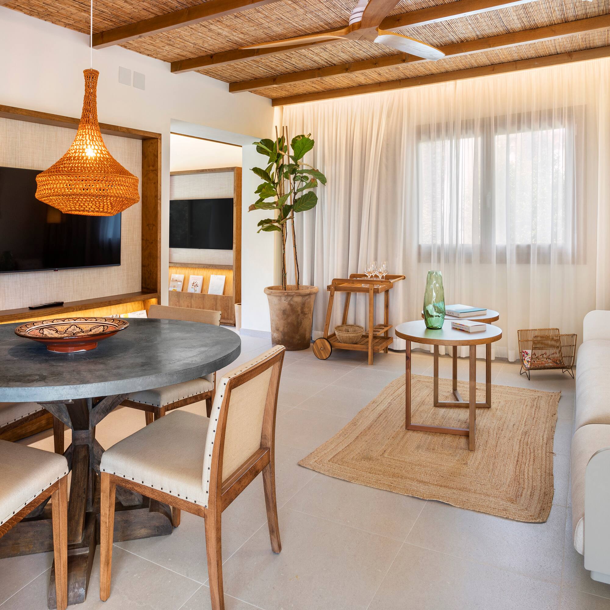 a living room with a table and chairs