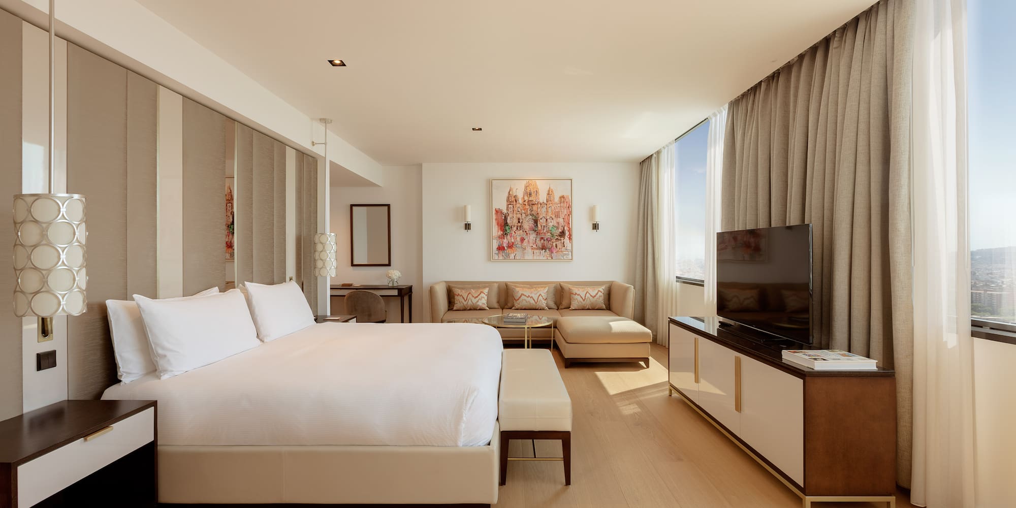 a bedroom with a large bed and a television