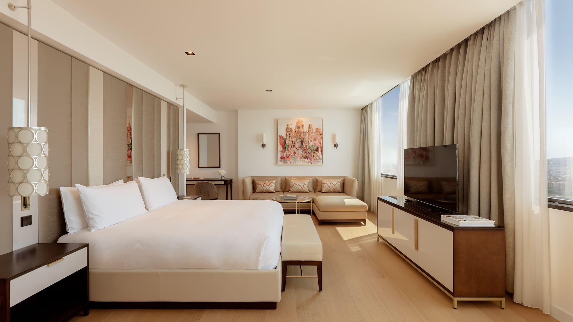 a bedroom with a large bed and a television