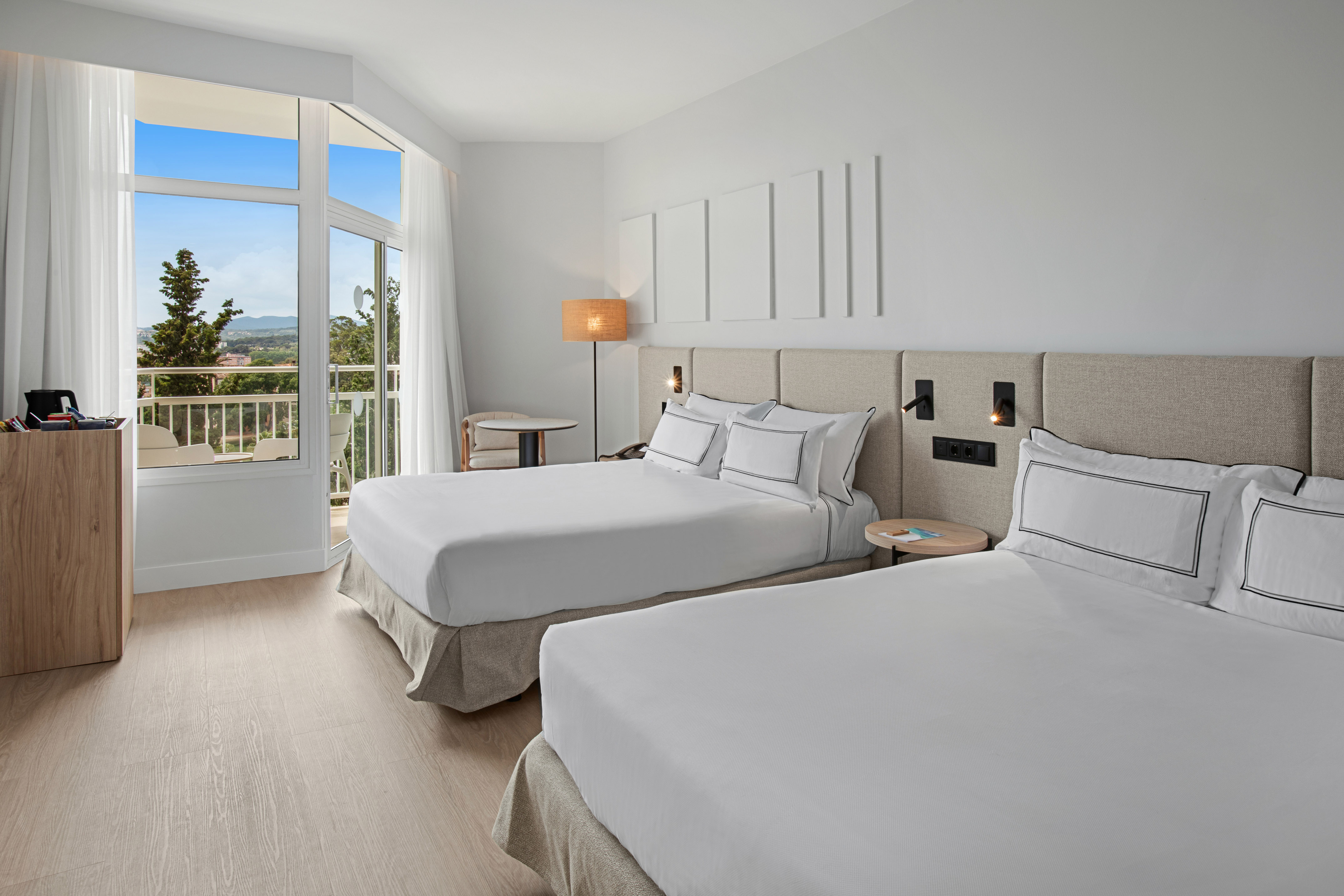 a room with two beds and a balcony