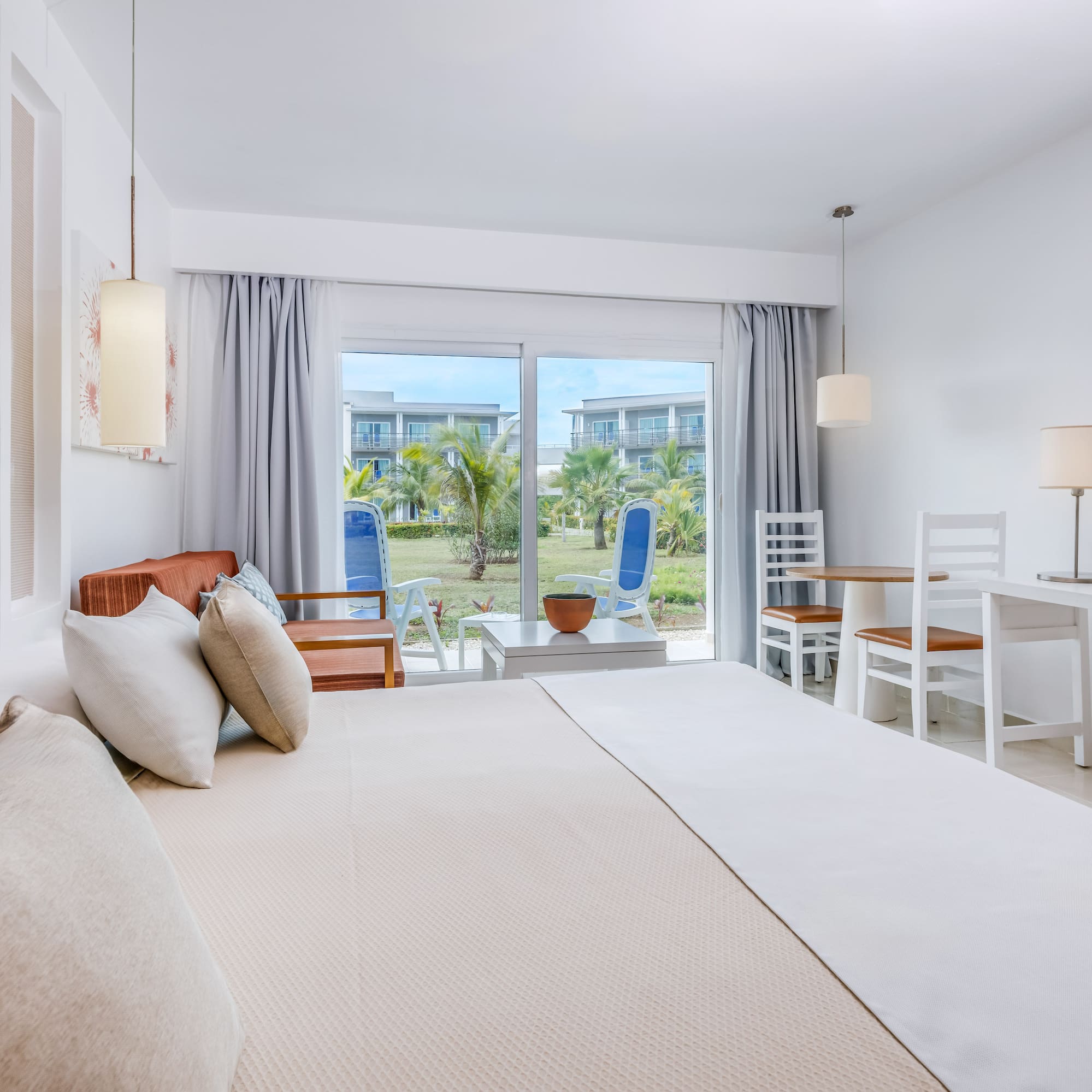 a bedroom with a bed and chairs and a table