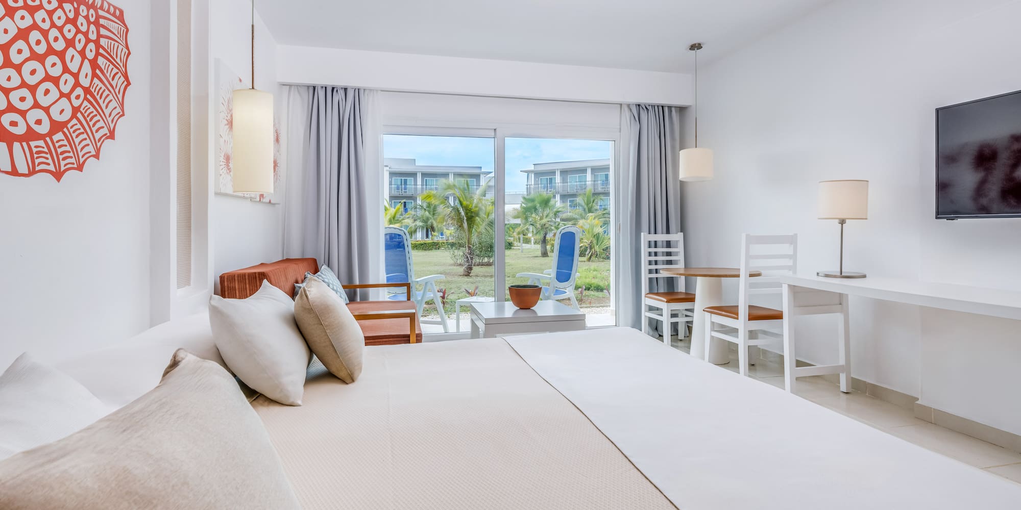 a bedroom with a bed and chairs and a table