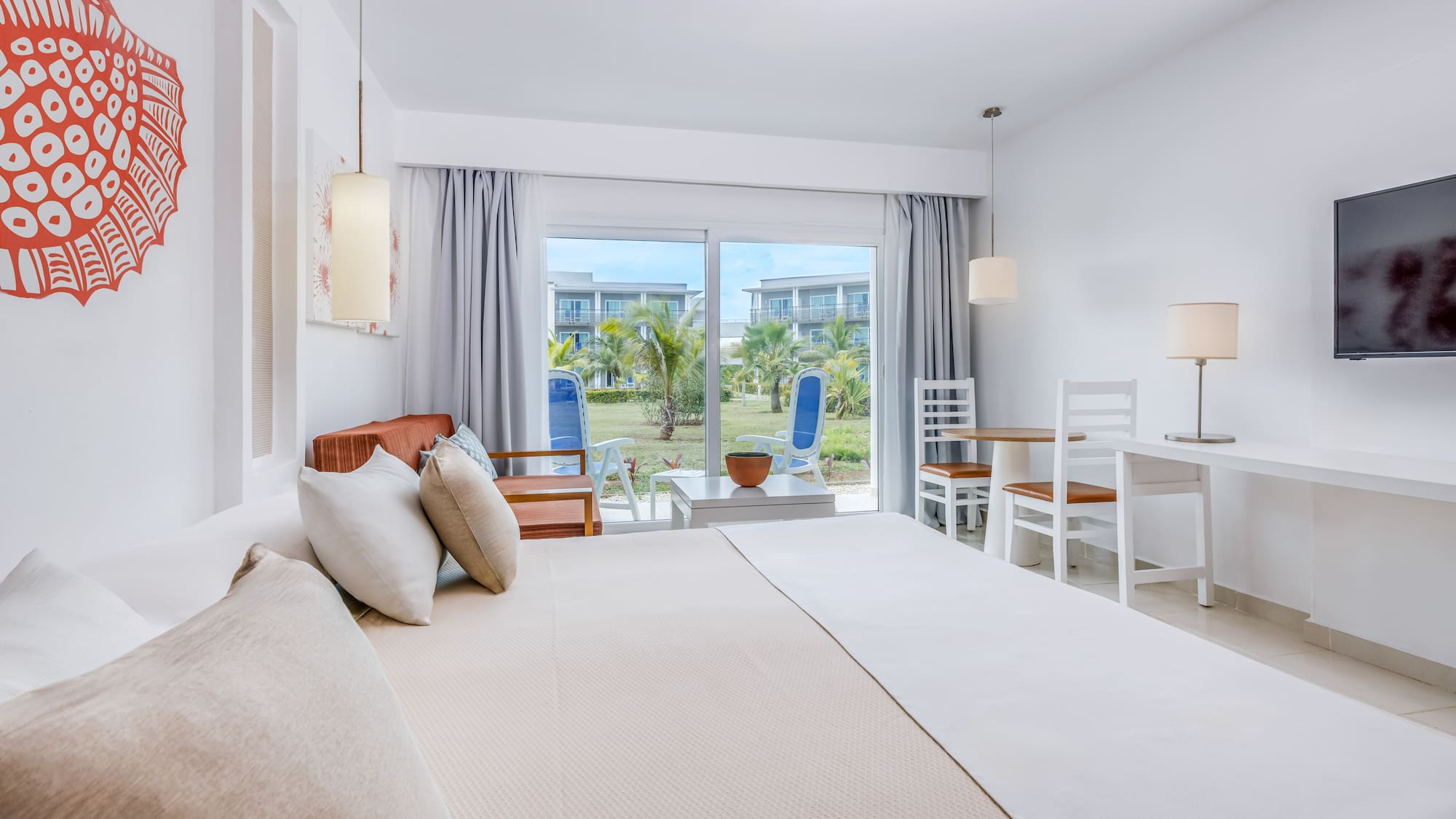 a bedroom with a bed and chairs and a table