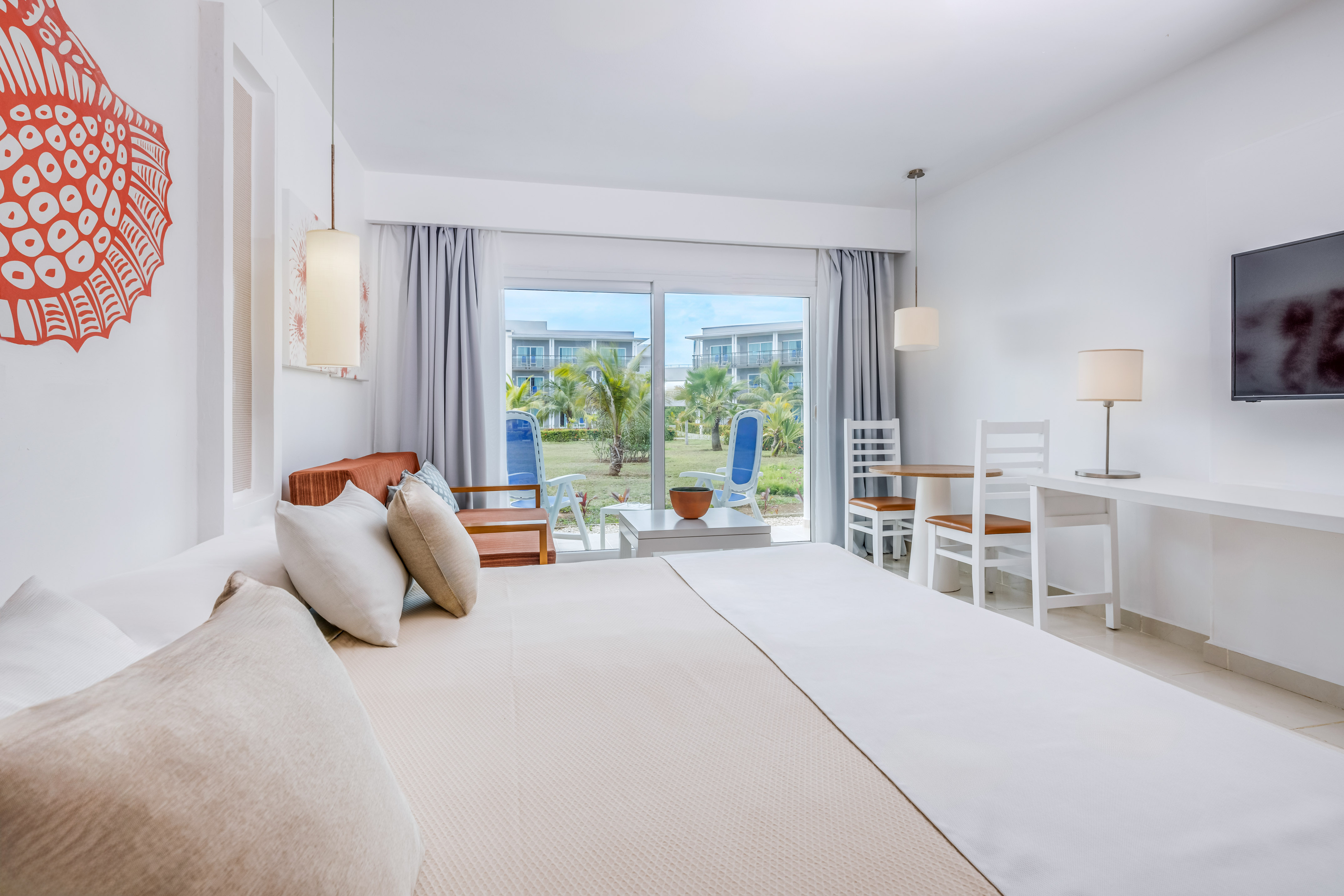 a bedroom with a bed and chairs and a table