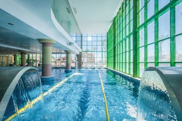a swimming pool with water and large windows