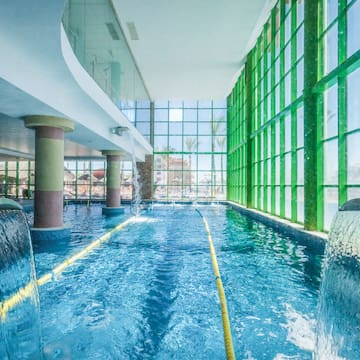 a swimming pool with water and large windows