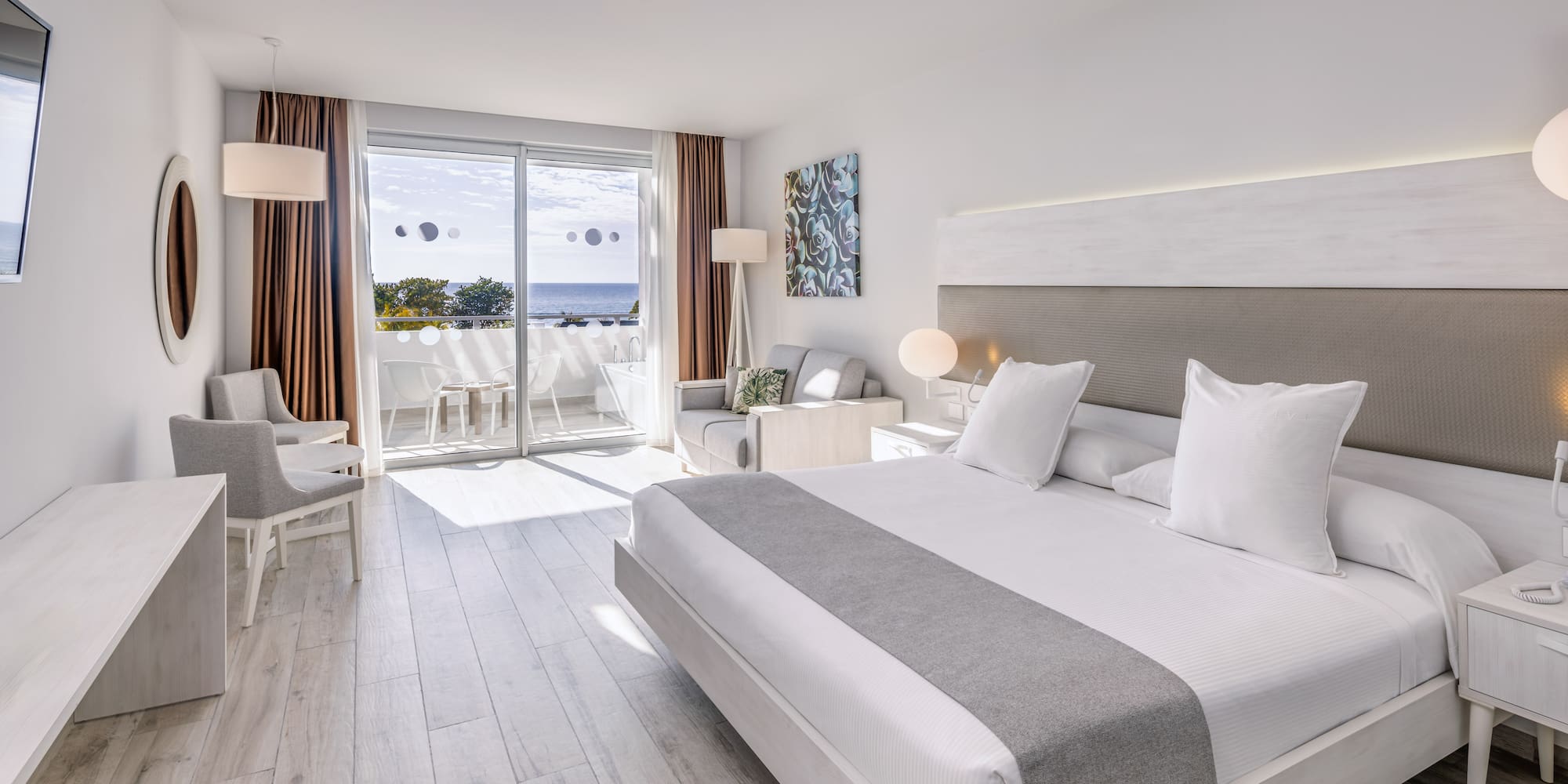 a room with a large bed and a glass door