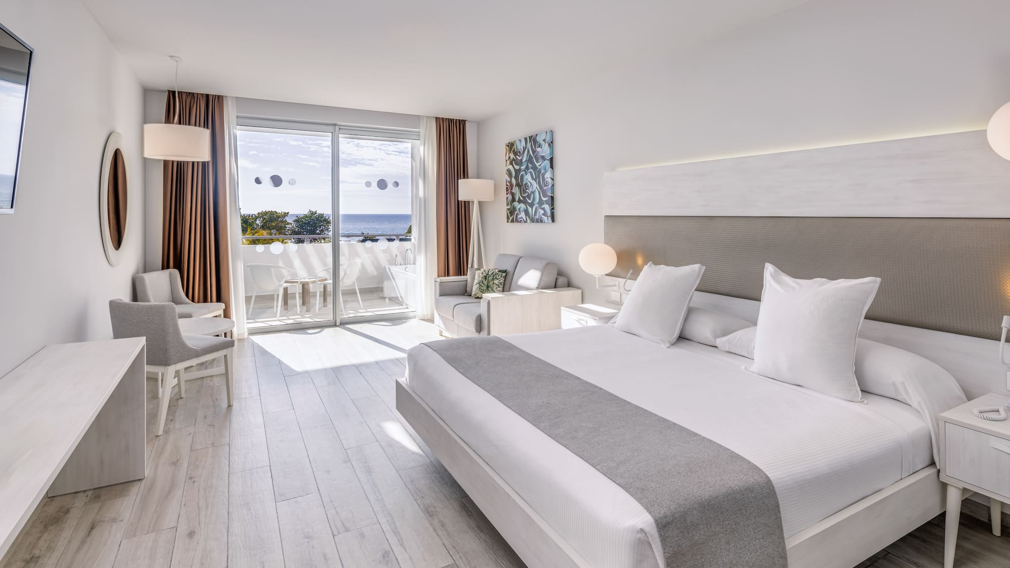 a room with a large bed and a glass door