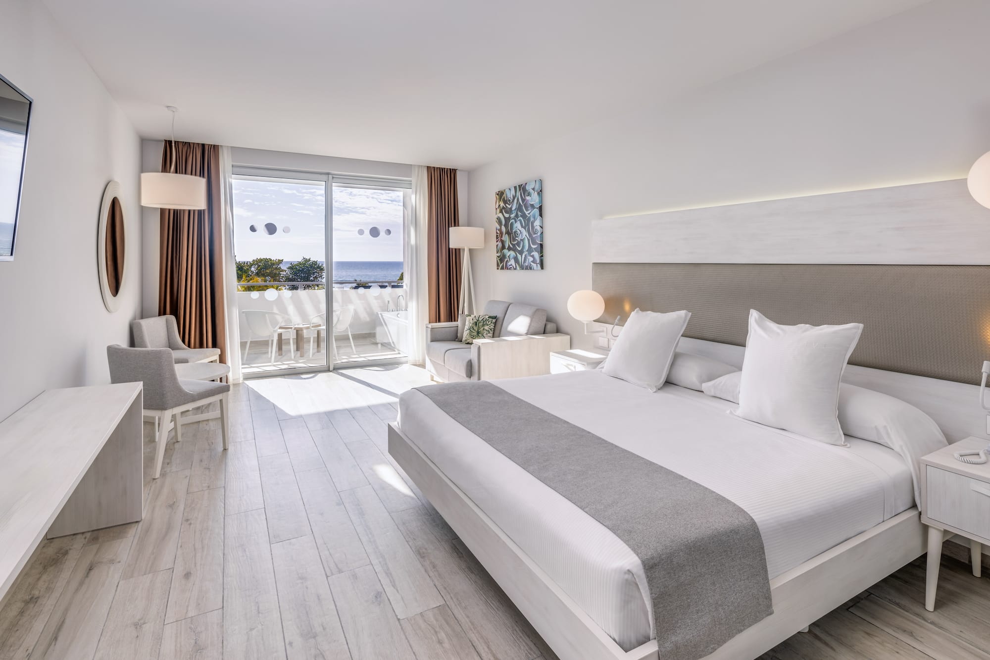 a room with a large bed and a glass door