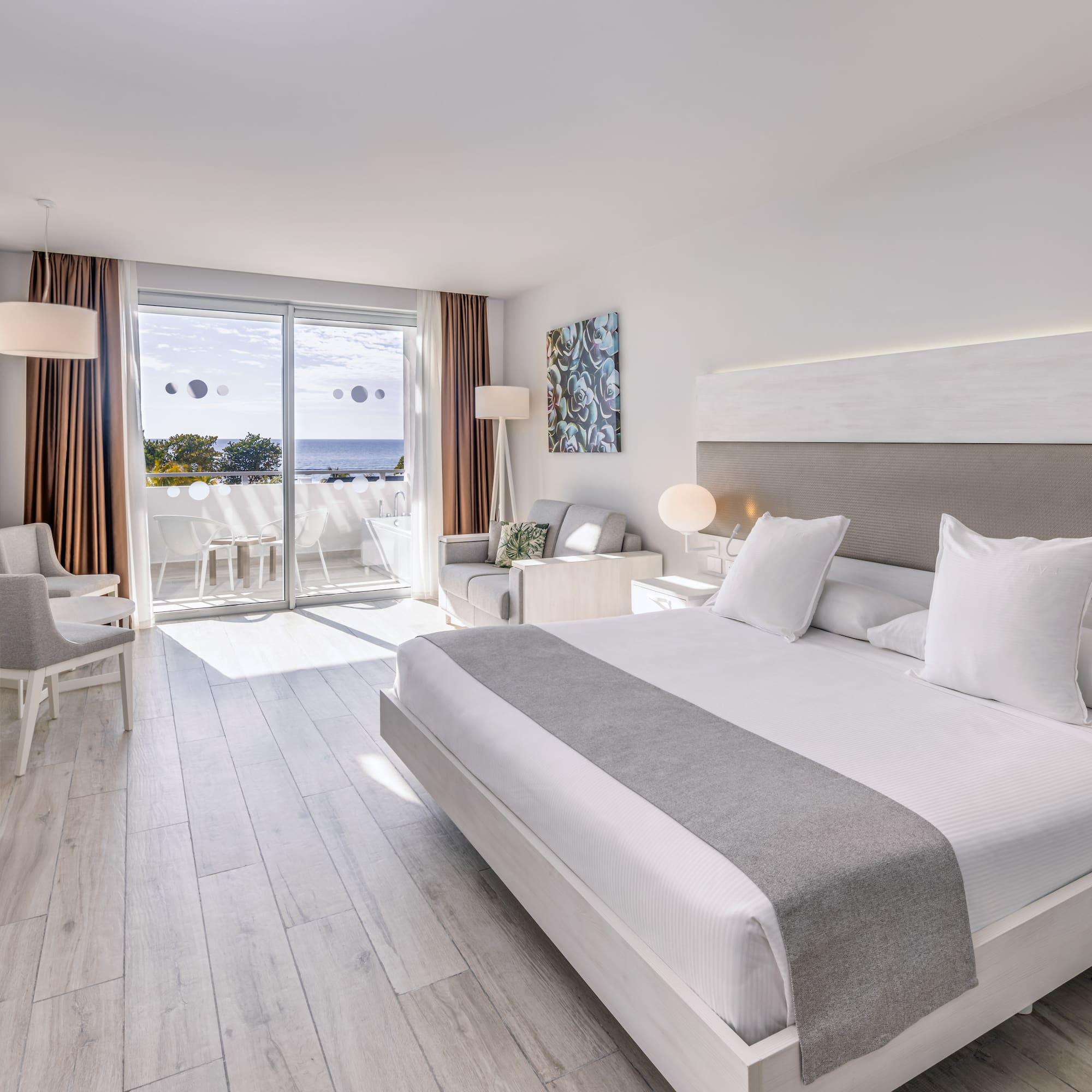 a room with a large bed and a glass door