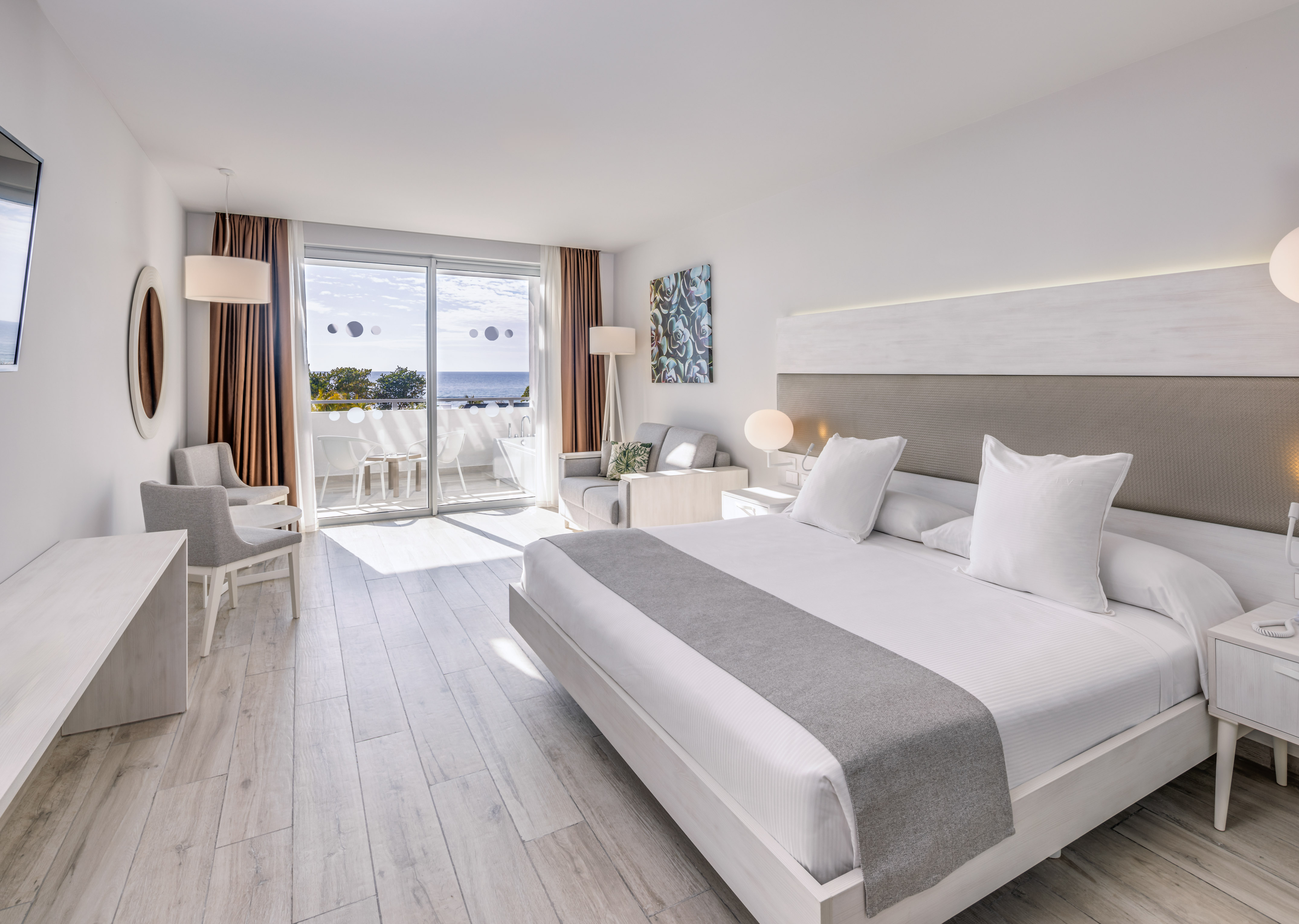 a room with a large bed and a glass door