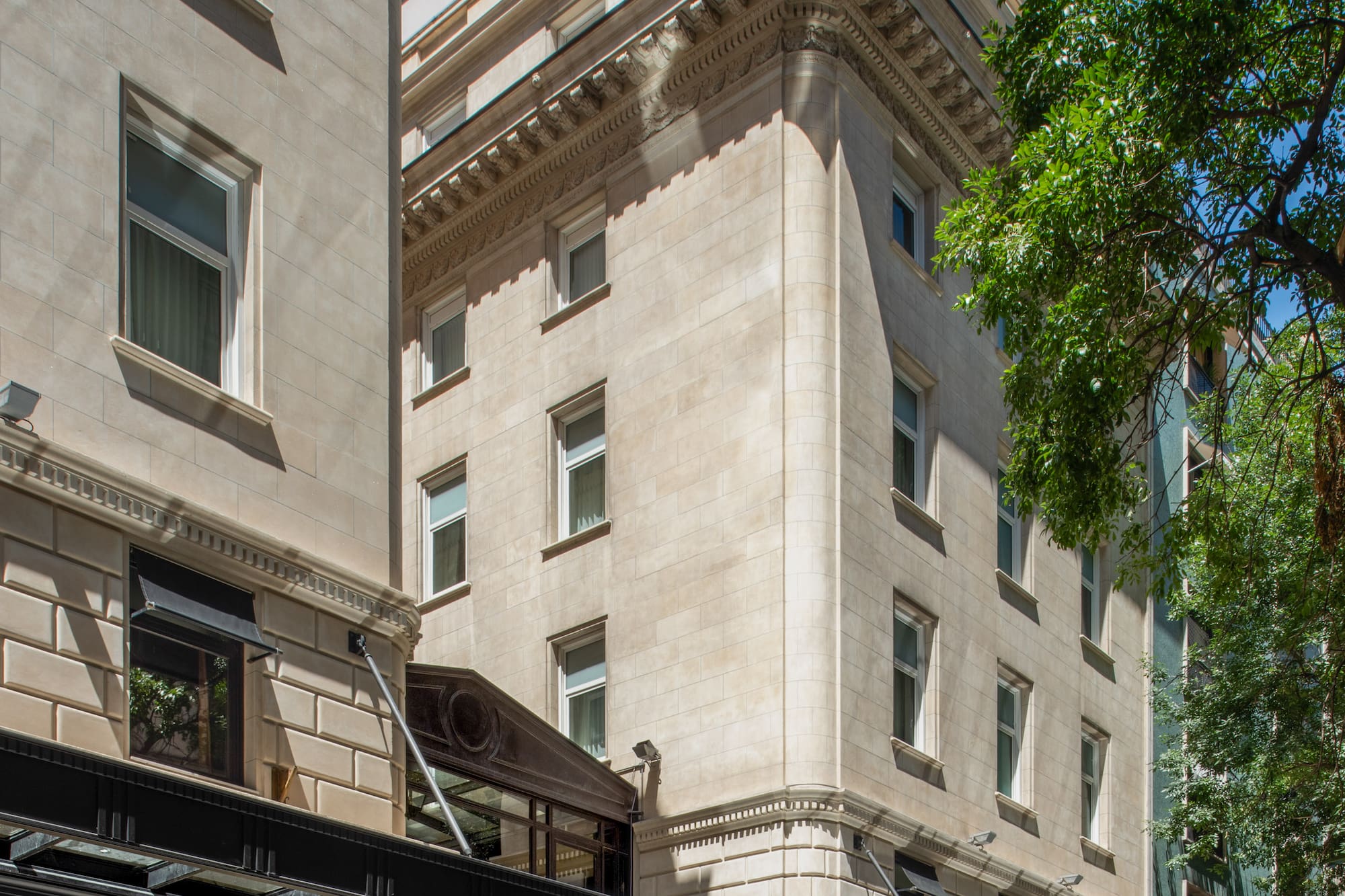 Historic Casa Lucia hotel's ornate stone facade, featuring a black entrance canopy.