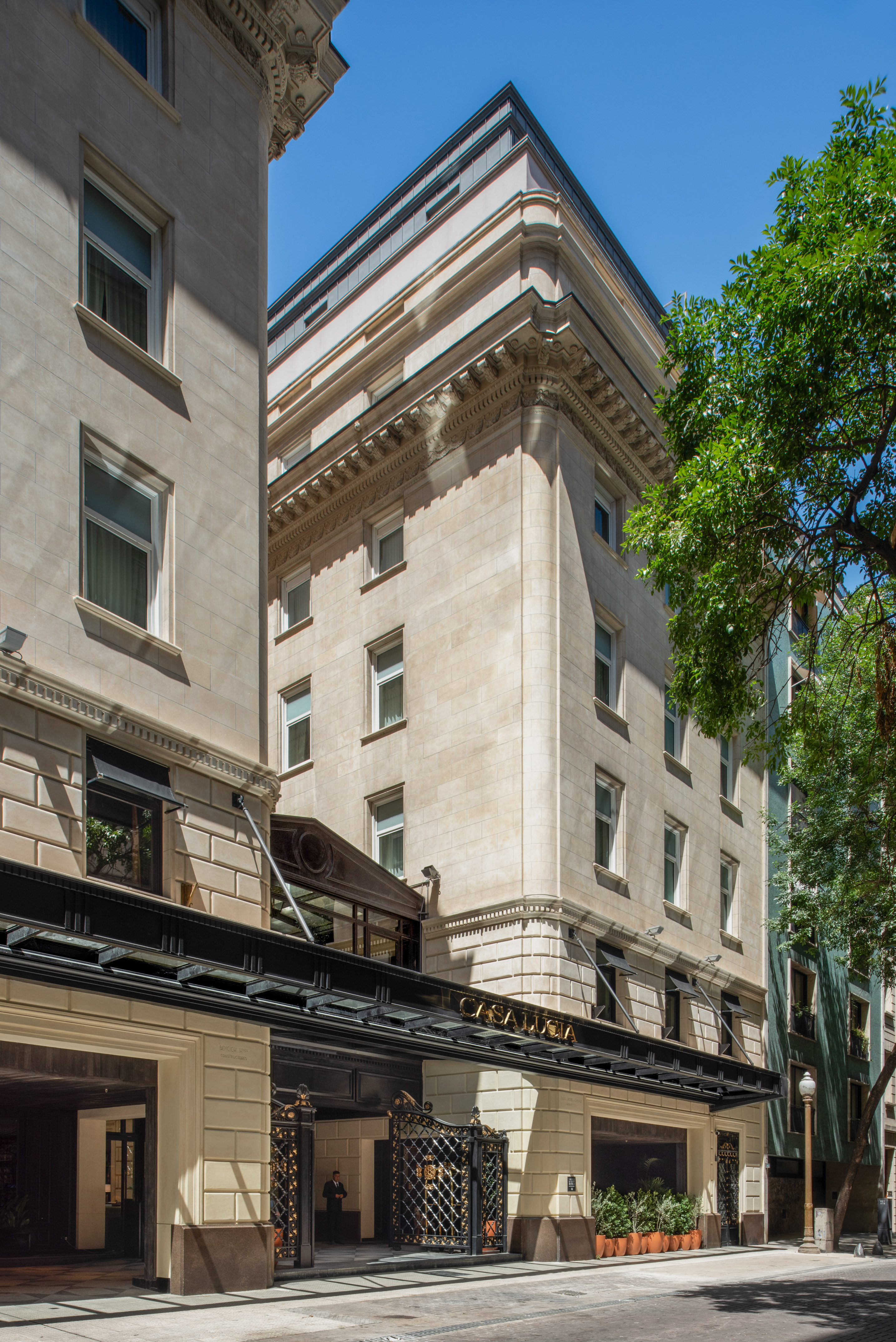 Historic Casa Lucia hotel's ornate stone facade, featuring a black entrance canopy.