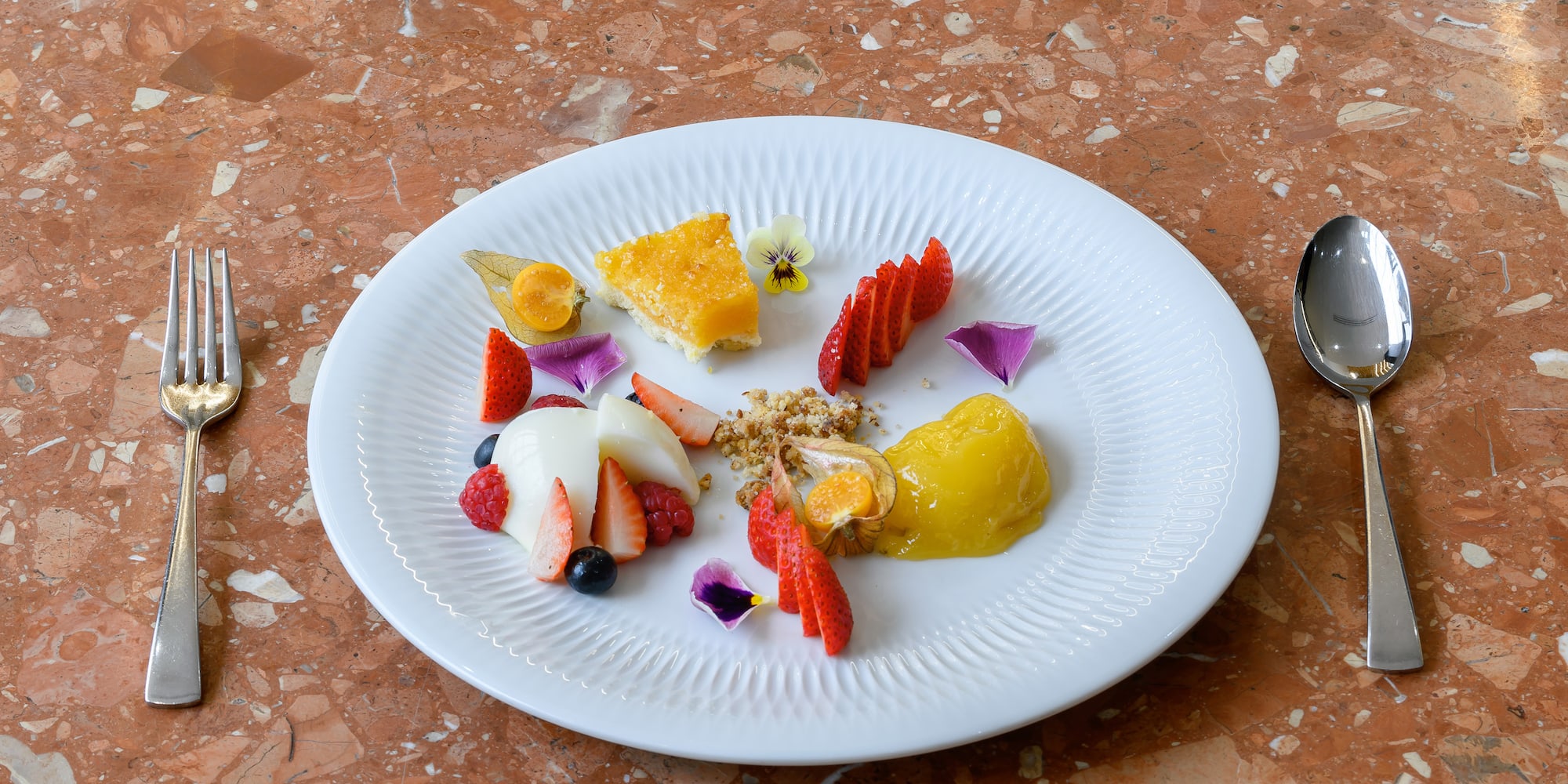 a plate of food on a marble surface