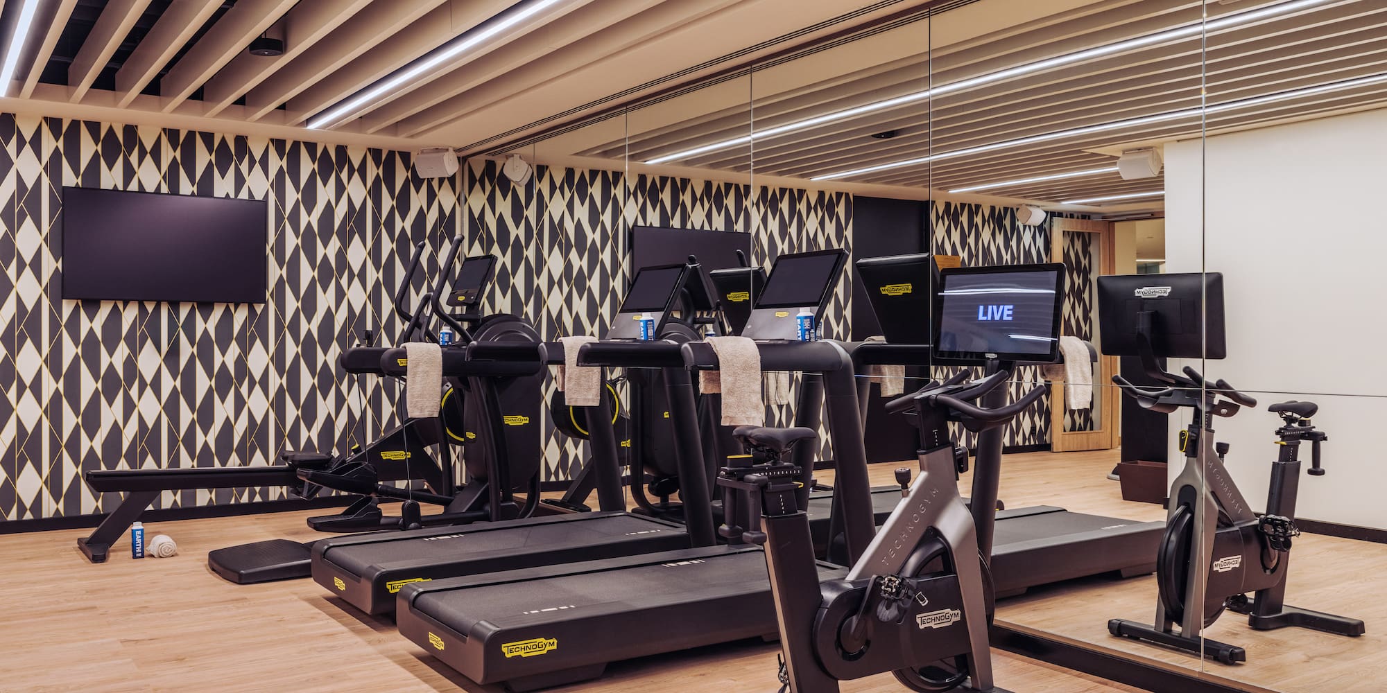 a room with treadmills and a mirror