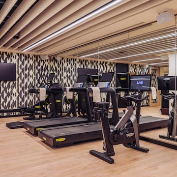 a room with treadmills and a mirror