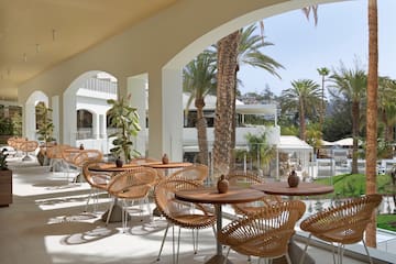 a patio with tables and chairs