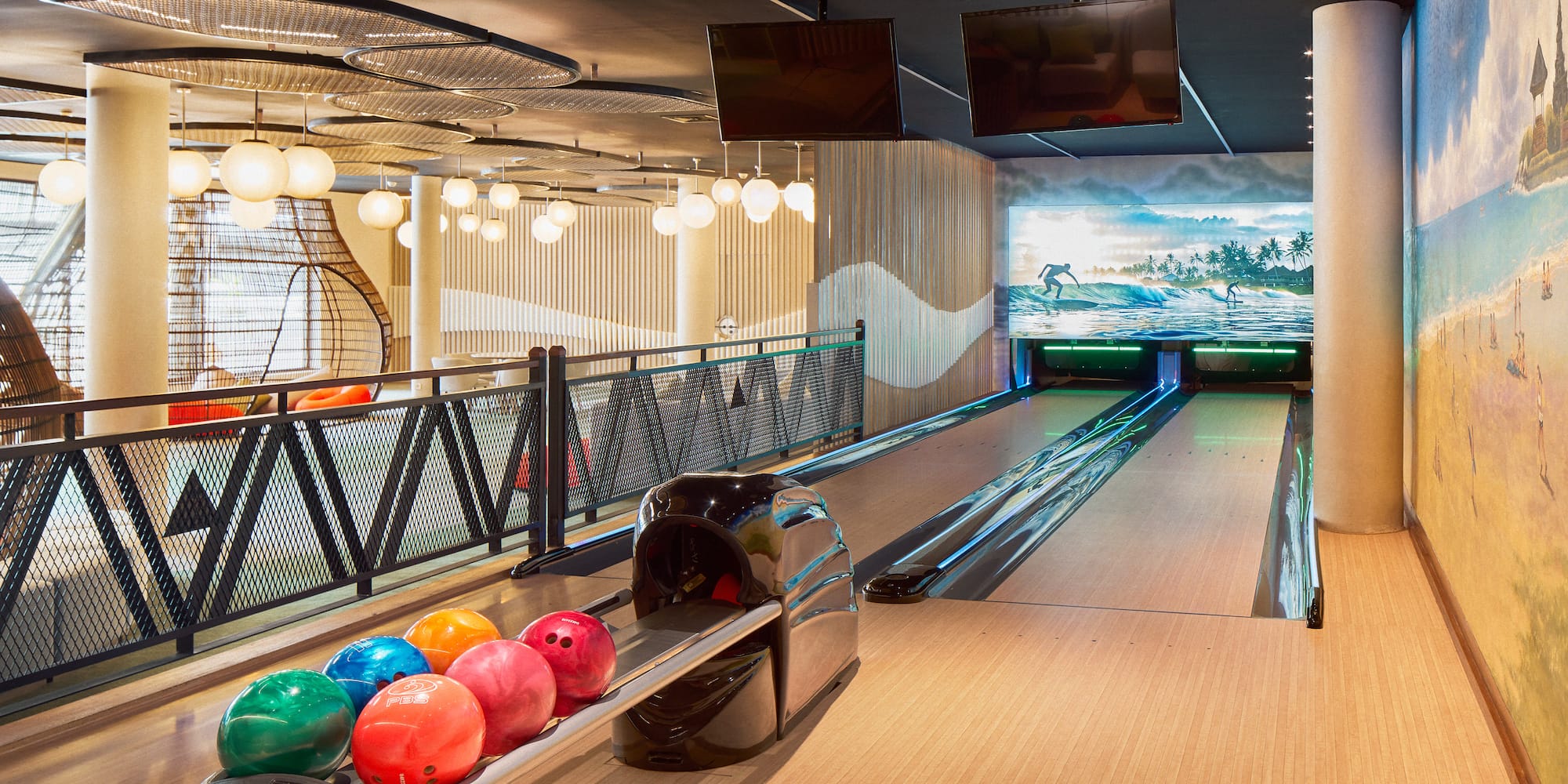 a bowling alley with balls on a rack