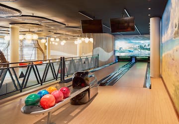 a bowling alley with balls on a rack