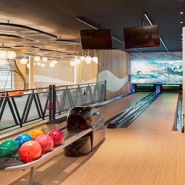 a bowling alley with balls on a rack