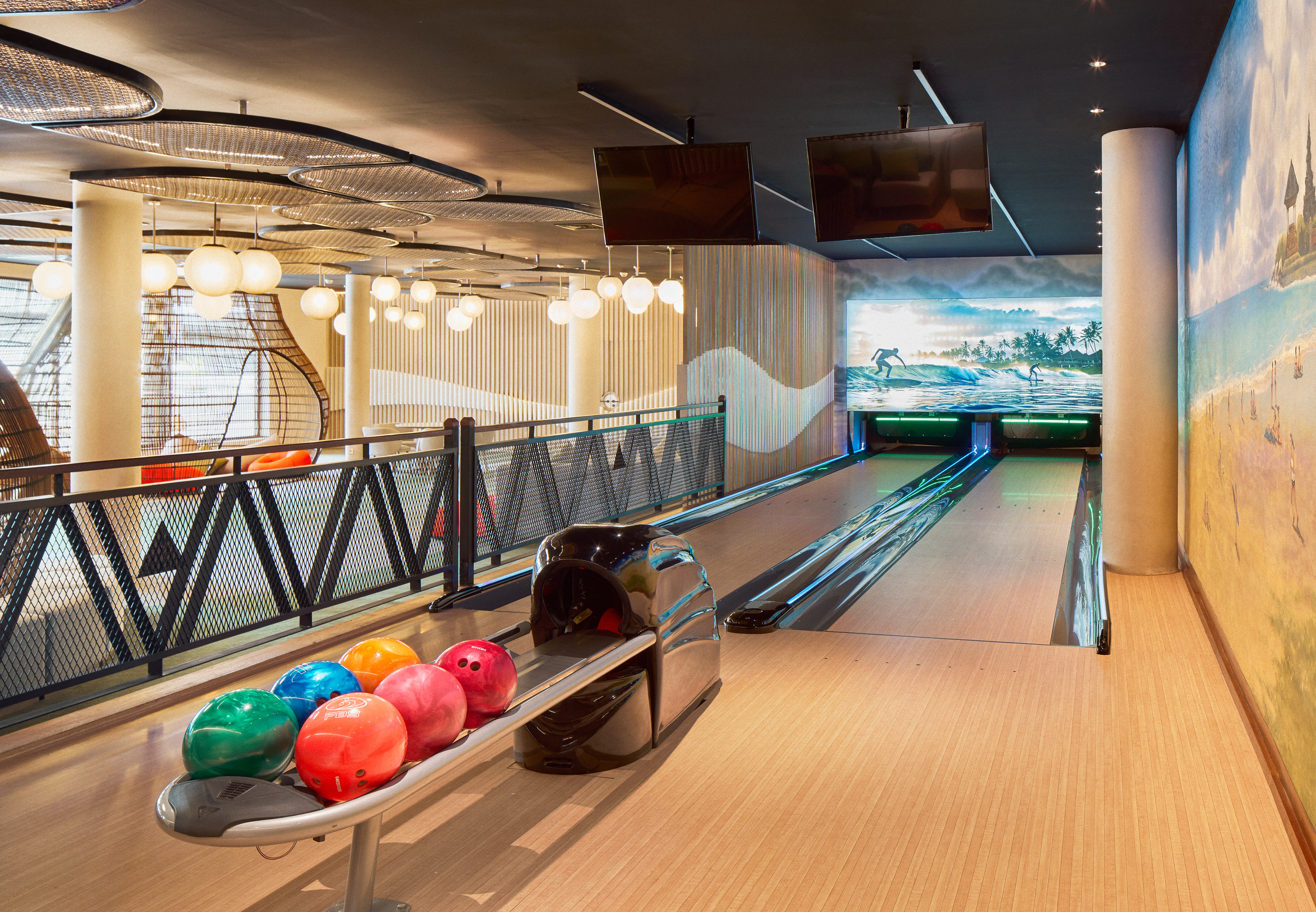a bowling alley with balls on a rack