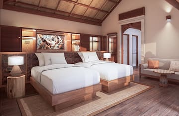 a room with two beds and a chair