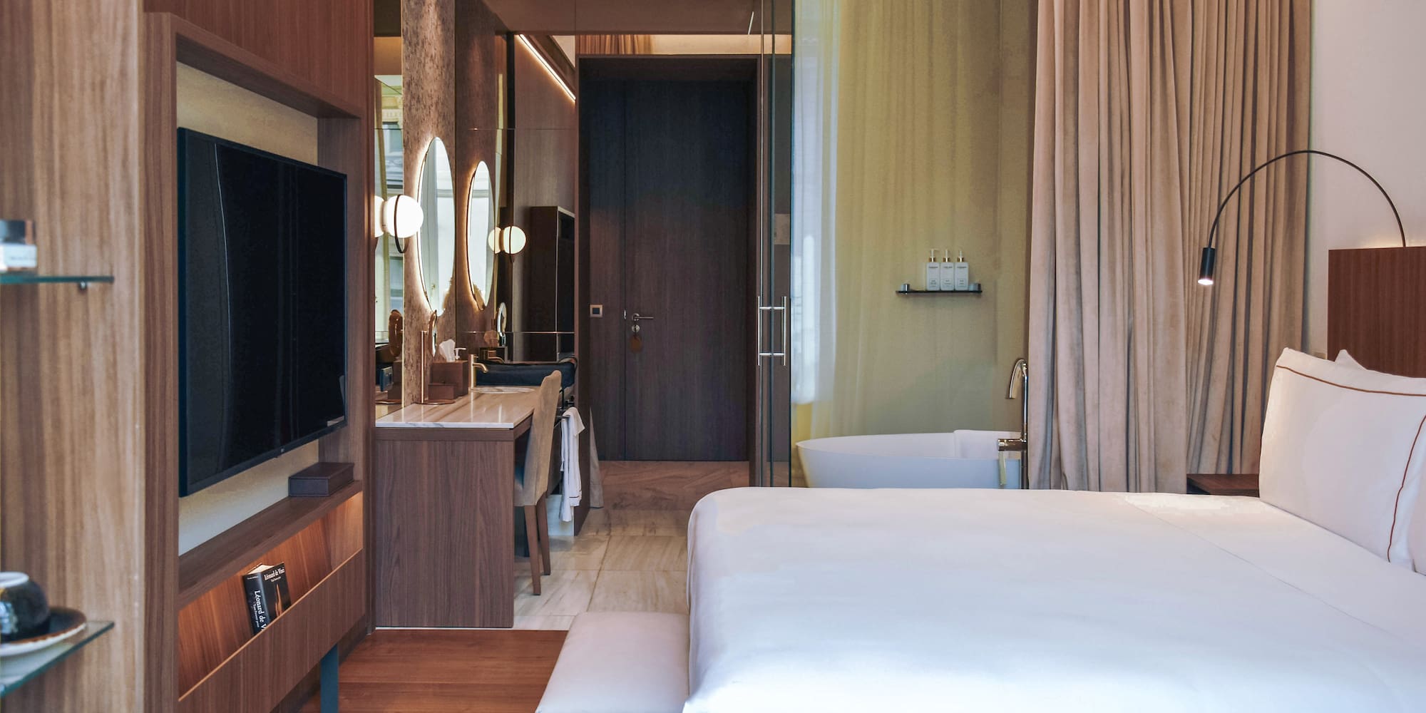 a bedroom with a television and a mirror