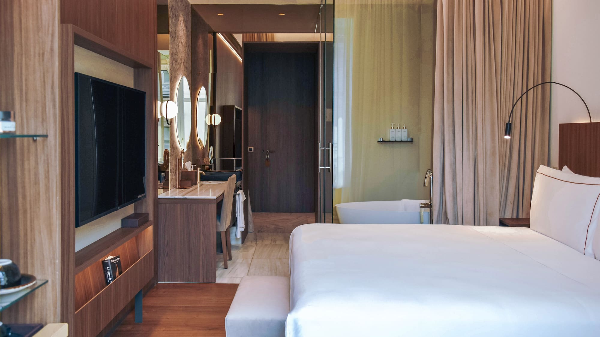 a bedroom with a television and a mirror