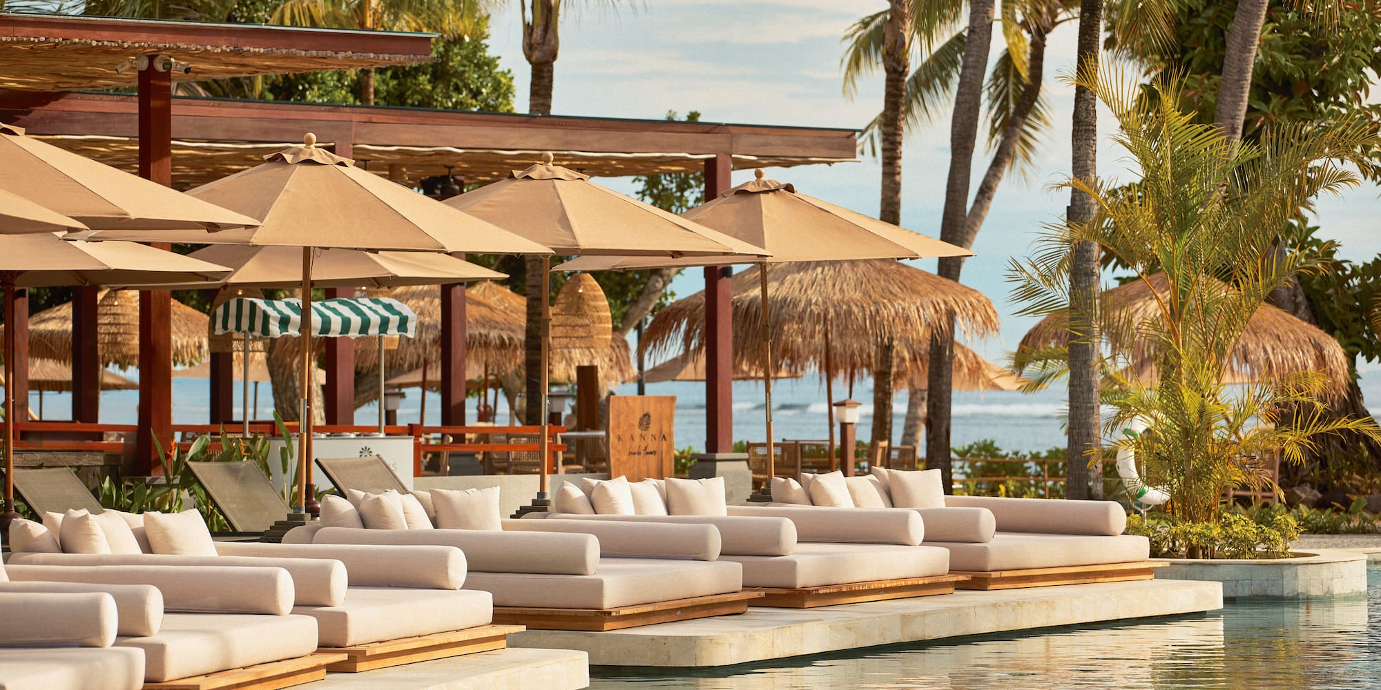 a pool with lounge chairs and umbrellas