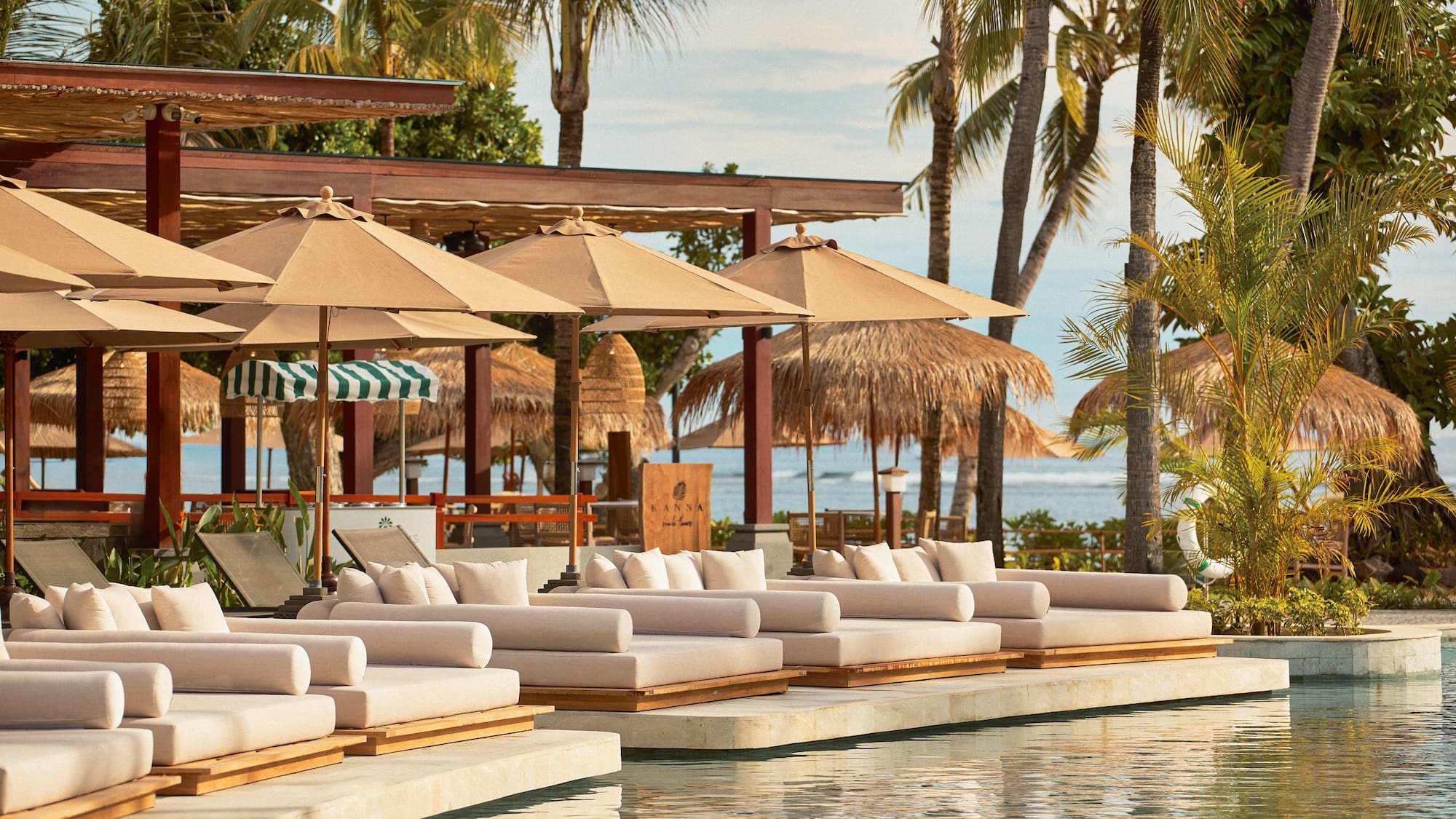 a pool with lounge chairs and umbrellas