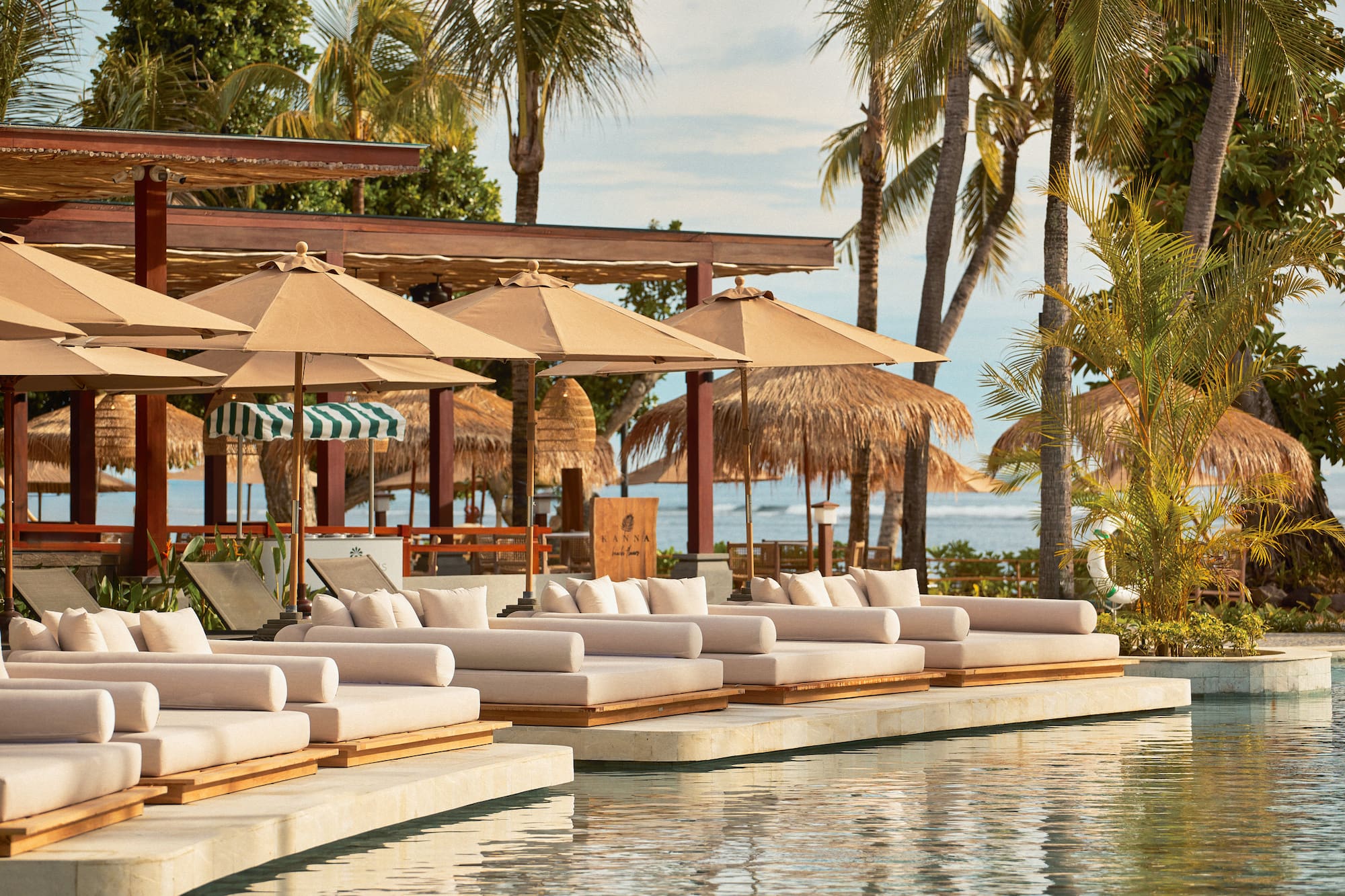a pool with lounge chairs and umbrellas