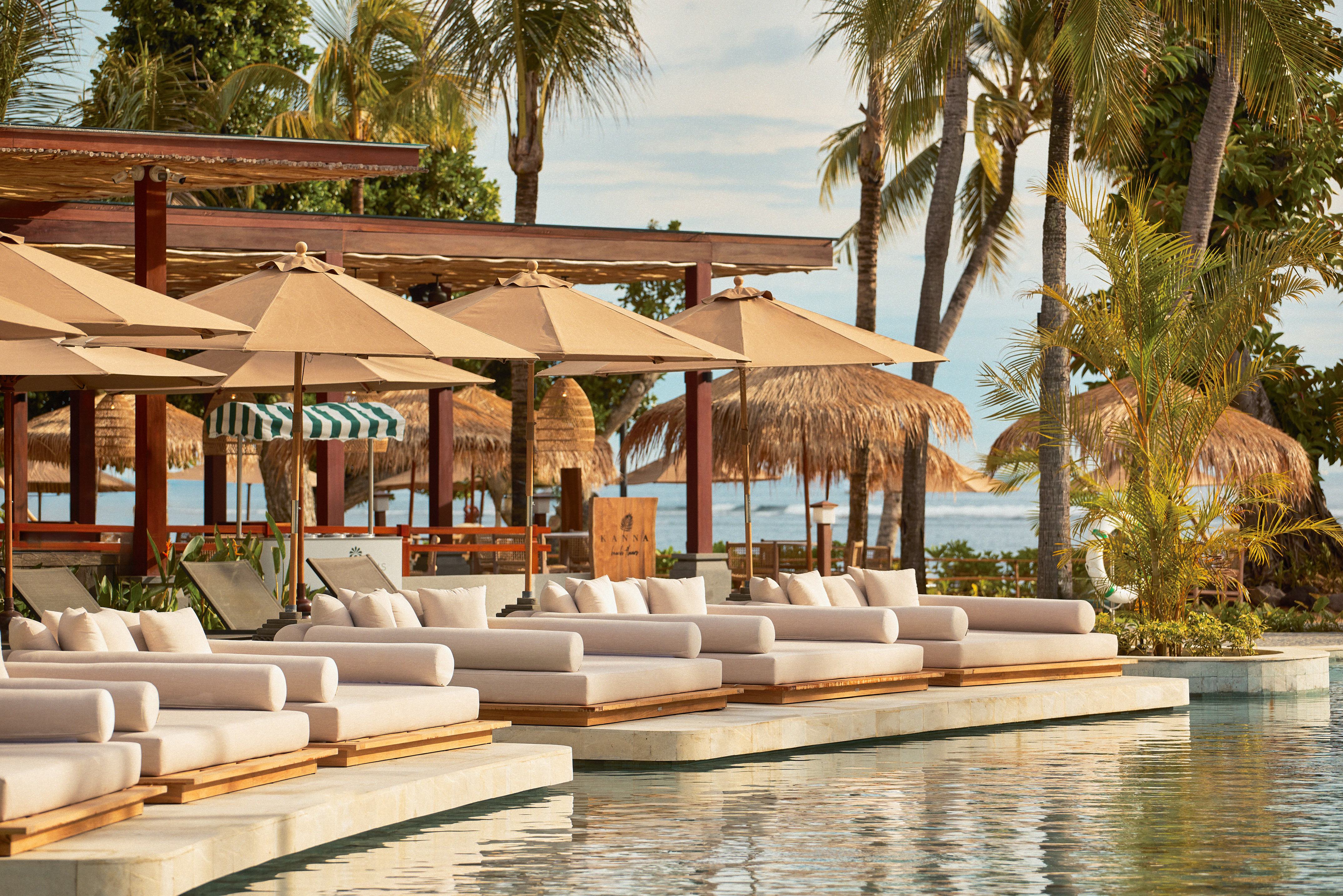 a pool with lounge chairs and umbrellas