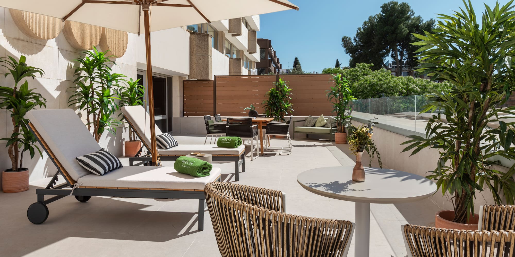 a patio with chairs and umbrellas