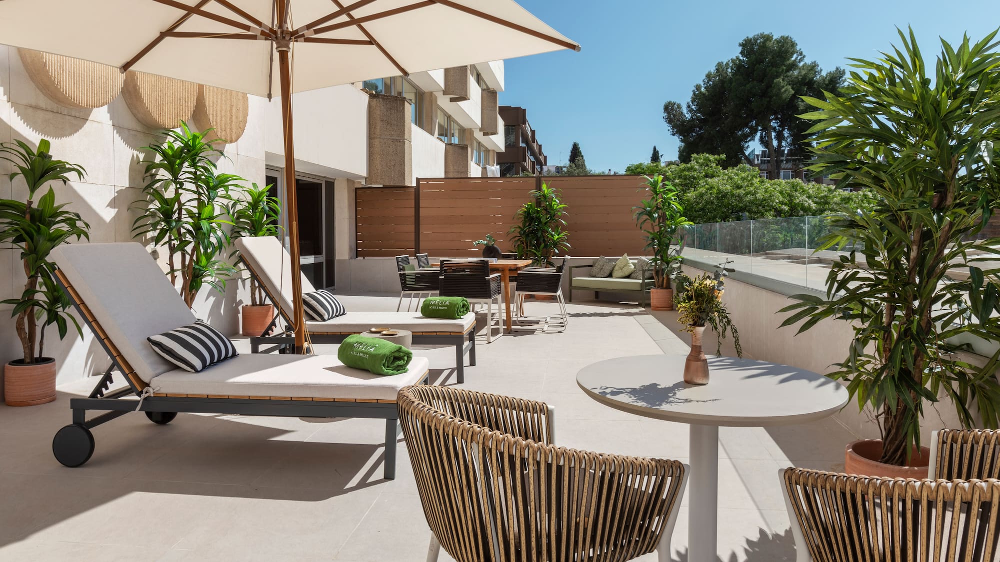 a patio with chairs and umbrellas