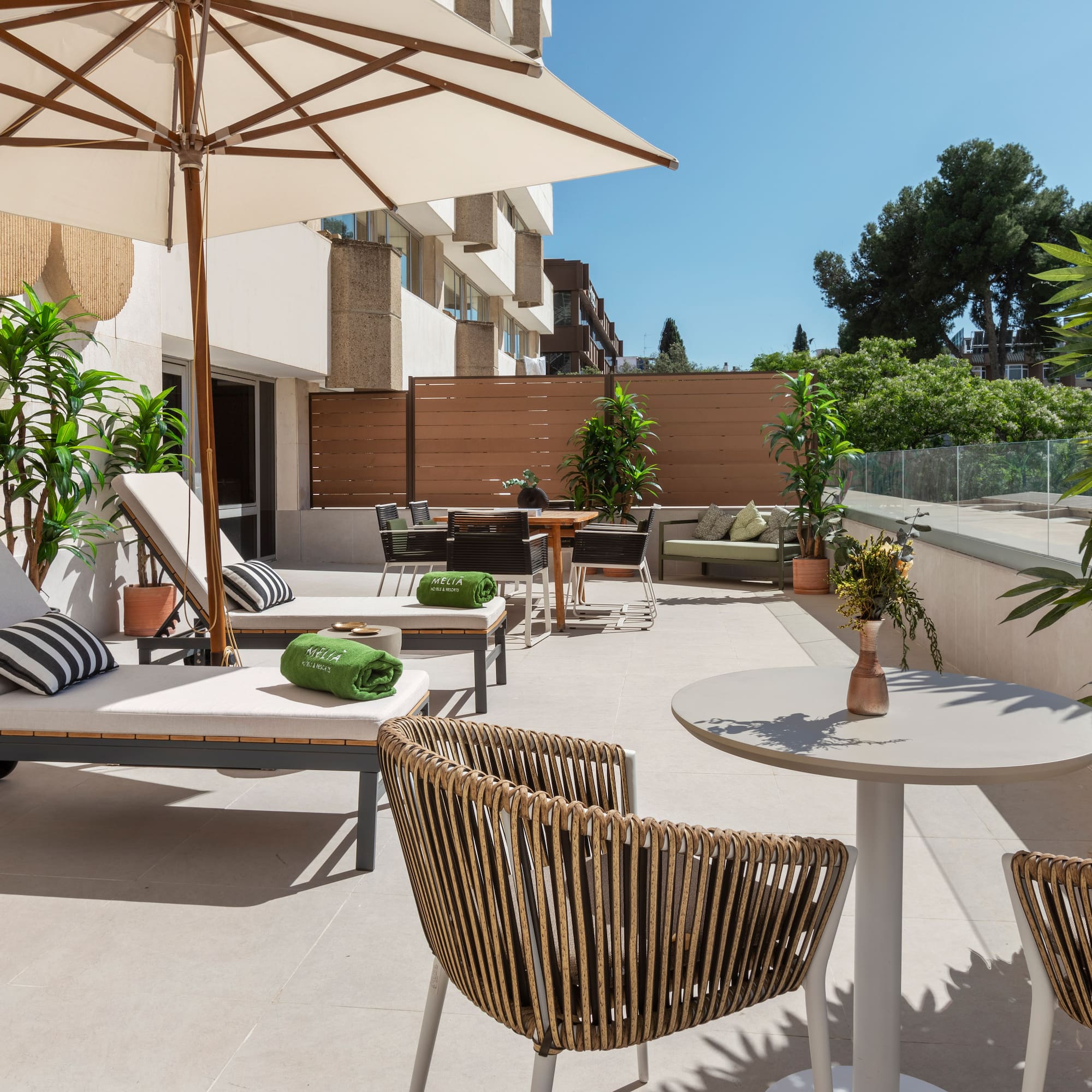 a patio with chairs and umbrellas