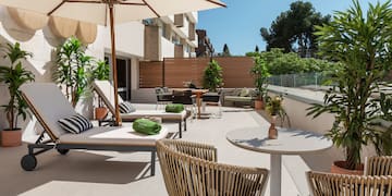 a patio with chairs and umbrellas