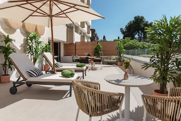 a patio with chairs and umbrellas