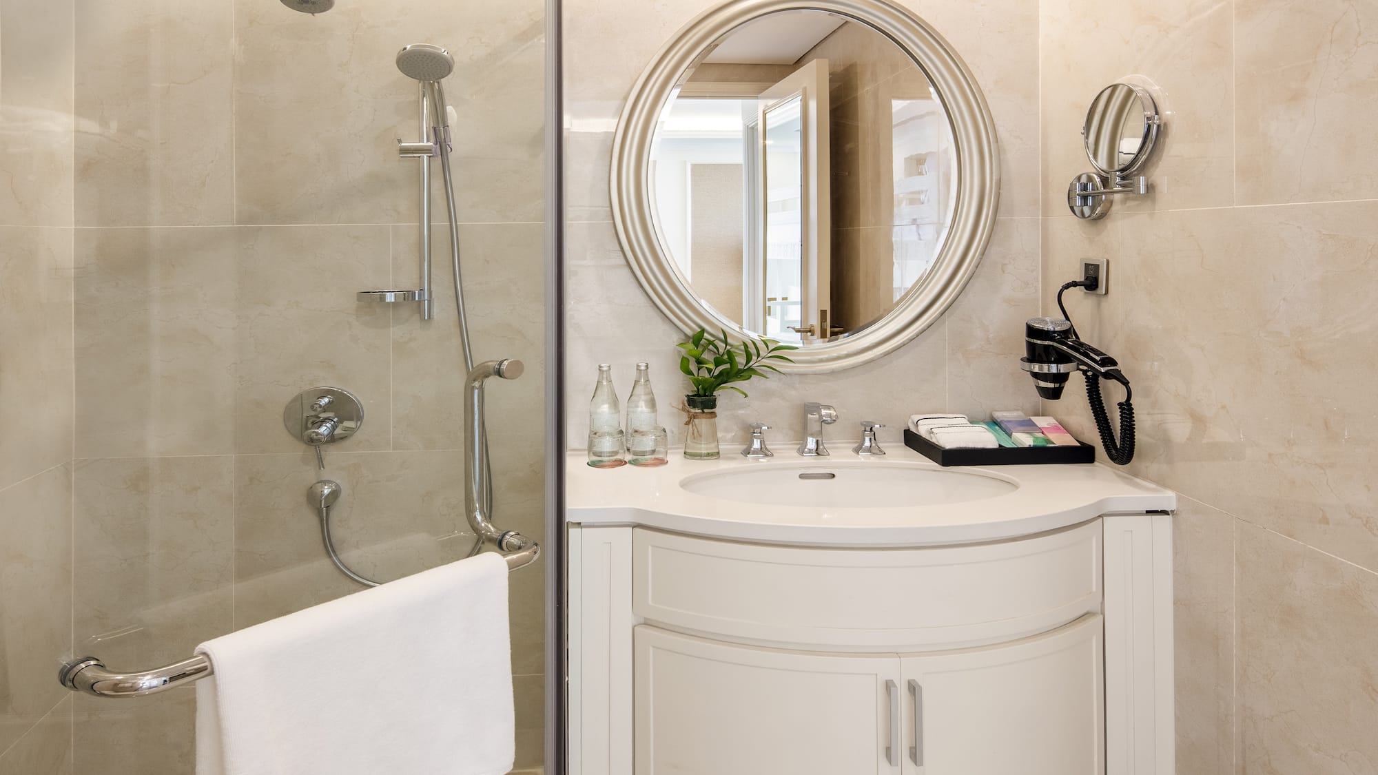 a bathroom with a round mirror and shower