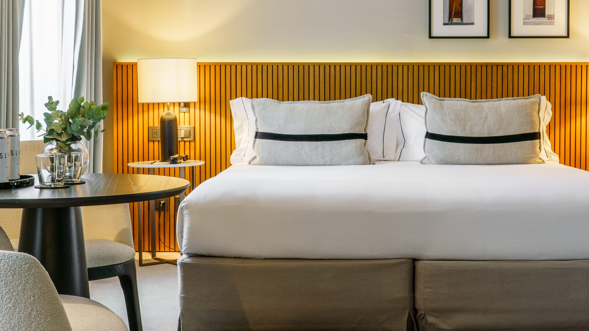 a bed with a table and chairs in a room