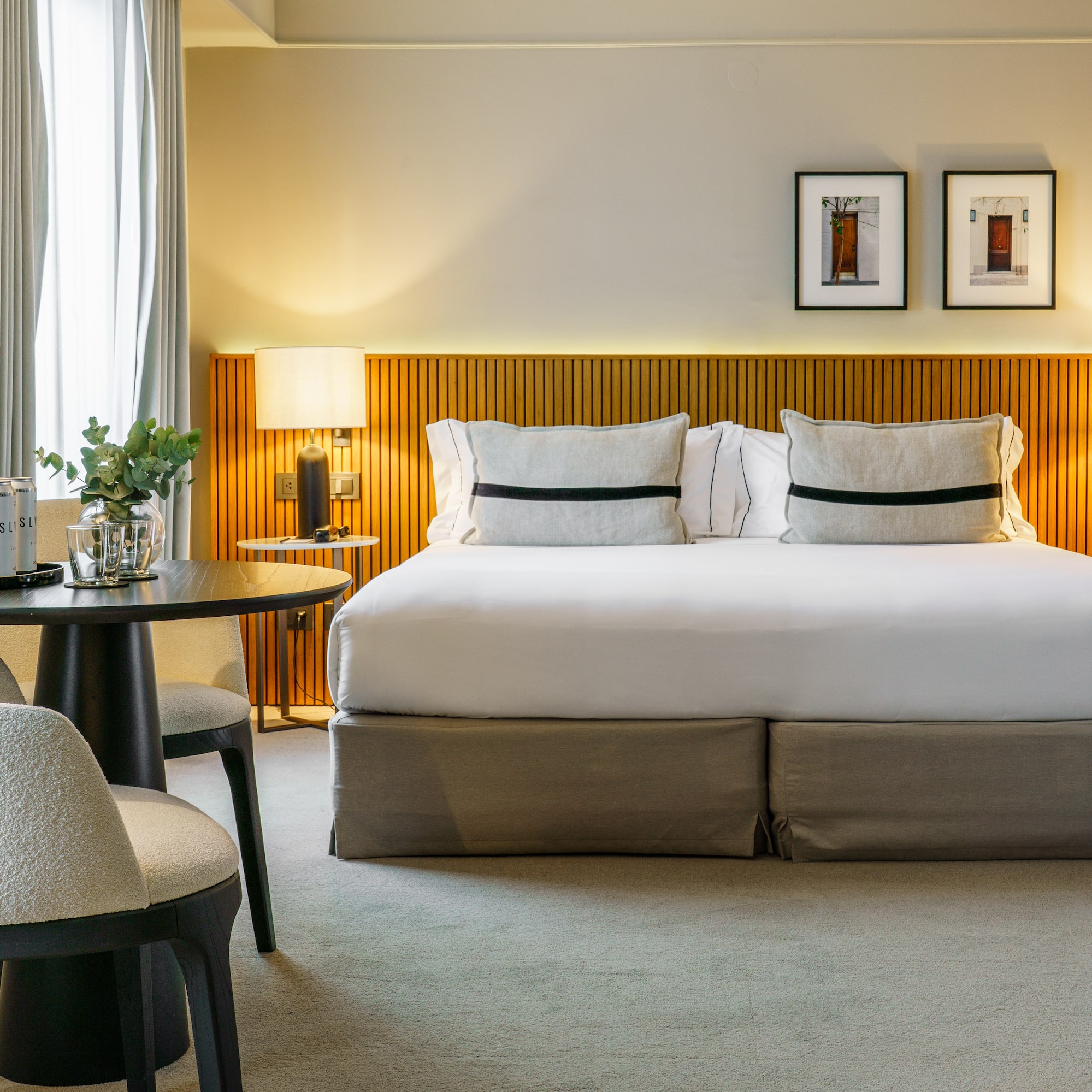 a bed with a table and chairs in a room