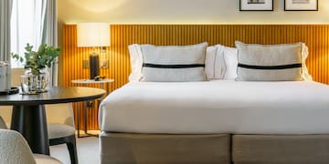 a bed with a table and chairs in a room