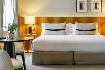 a bed with a table and chairs in a room