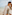 Smiling couple walking on tropical beach with ocean waves.
