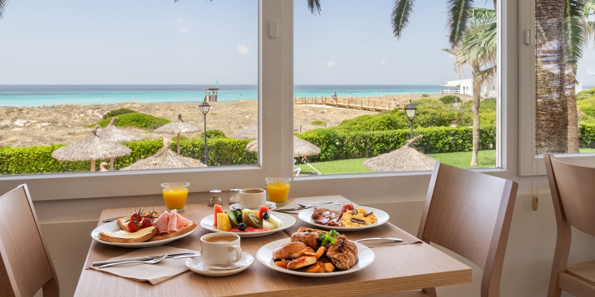 a table with plates of food and drinks on it