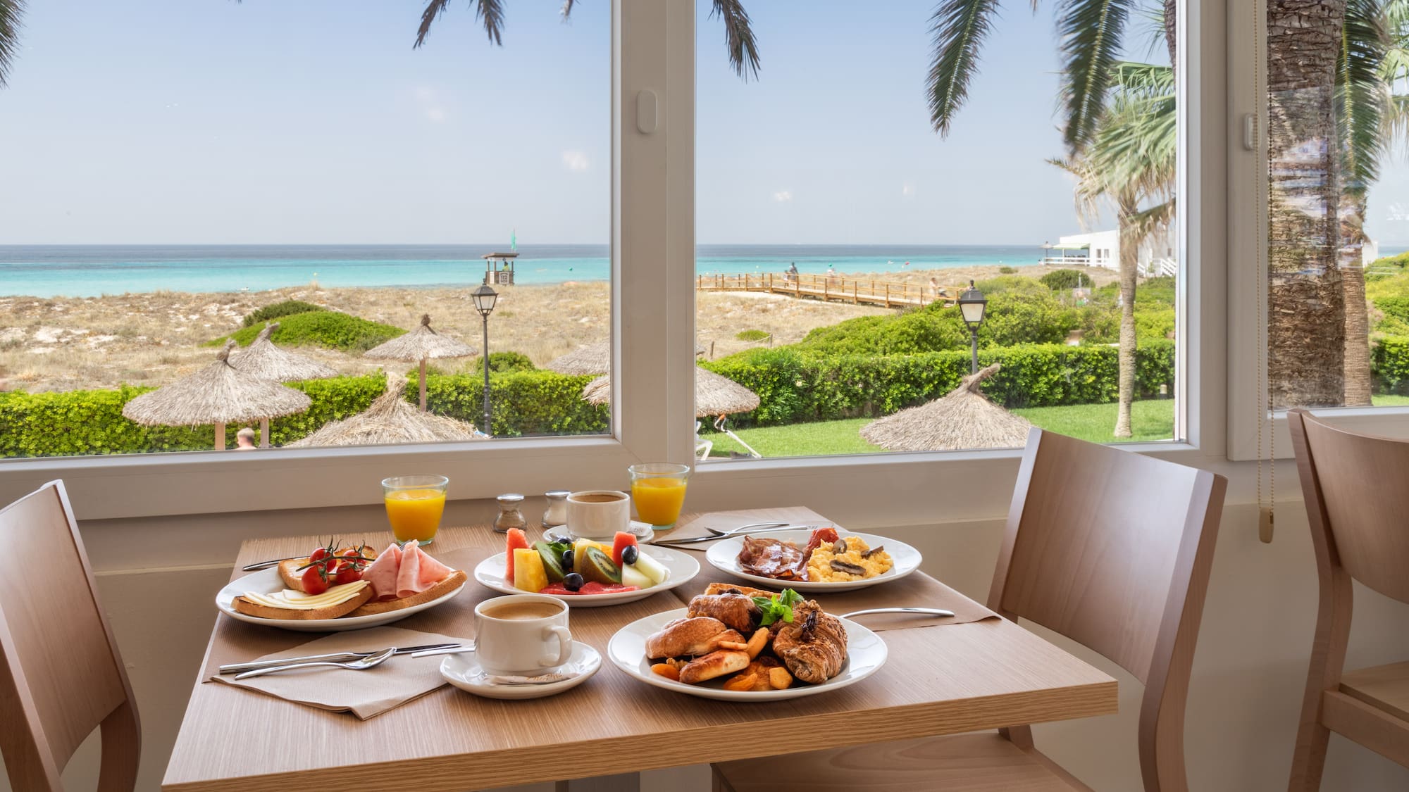 a table with plates of food and drinks on it